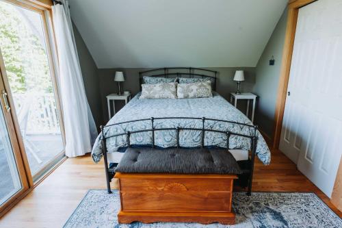 a bedroom with a bed and a large window at Finger Lakes Home with Private Pool and Lake Views! in Hammondsport