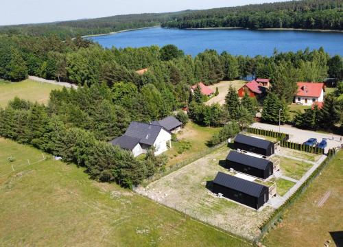 an aerial view of a house with a lake at Wynki no. 69 in Łukta