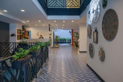 a lobby of a restaurant with plants on the walls at First Class Hotel by 5 Host in Medellín