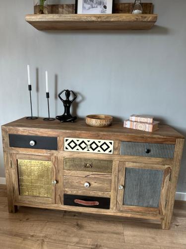 a wooden cabinet with two candles on top of it at Apartmán MATEO Donovaly in Donovaly