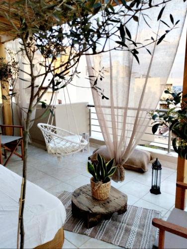 a room with a hammock and a tree in it at Riviera in Agios Nikolaos