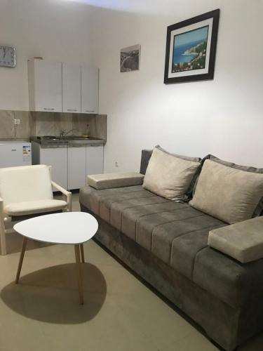 a living room with a couch and a table at Montebello Inn apartments in Ulcinj