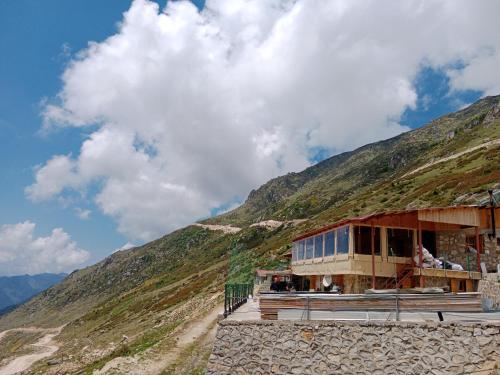 a building on the side of a mountain at Avusor mola cafe pansiyon in Çamlıhemşin