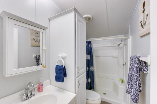 a white bathroom with a sink and a shower at Dock, Deck and Kayaks Home on Cedar Creek Reservoir in Mabank