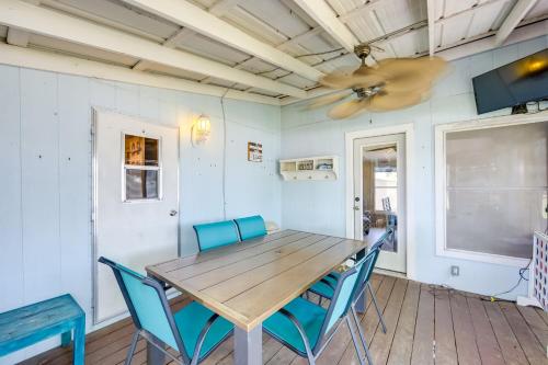 a dining room with a wooden table and blue chairs at Dock, Deck and Kayaks Home on Cedar Creek Reservoir in Mabank