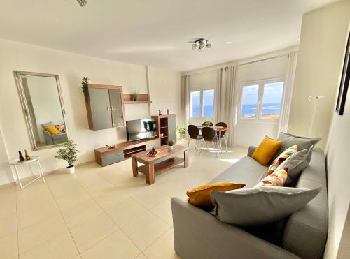 a living room with a couch and a table at ChocolateCream Luxury in Bajamar