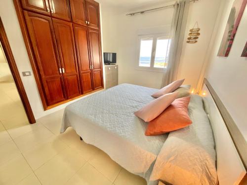 a bedroom with a bed with pillows on it at ChocolateCream Luxury in Bajamar