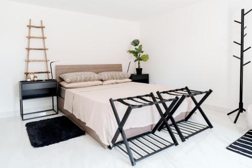 a bedroom with a bed with a white wall at La Stanza del Relax in San Donà di Piave