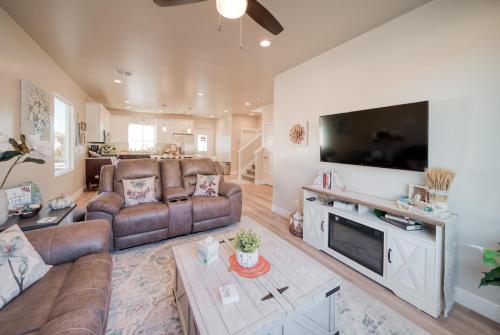 a living room with a large flat screen tv at South Zion Coral Cliffs - 4 bed, 3 bath, hot tub, deck in Hildale