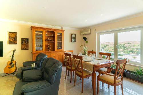 a dining room with a table and chairs at Family Comfort House in Seixal