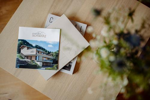 a table with two cards and a house on it at Appartement Schwarz in Sankt Johann im Pongau
