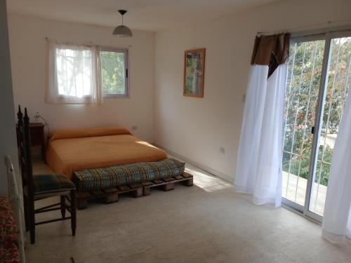 a bedroom with a bed and a window at Casa en Río Ceballos. Muy buena ubicación. in Río Ceballos