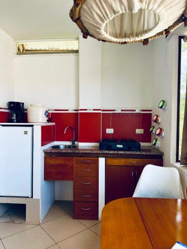 a kitchen with a sink and a counter top at CASA MOSAICO in Puerto López