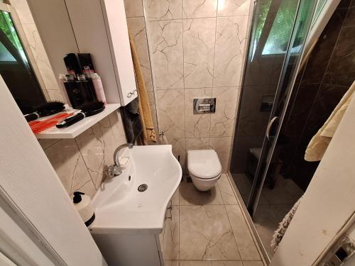 a bathroom with a toilet and a sink and a shower at Villa İnci in Cesme