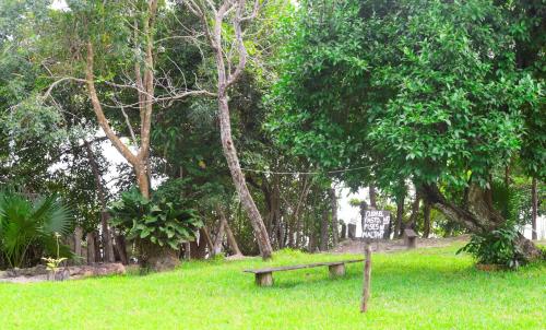 a park with a bench and a sign in the grass at Loft by Yuum Kiin Bacalar in Rancho Bacalar