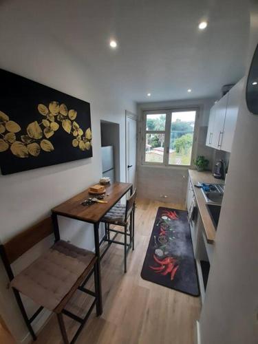 une cuisine avec une table et des chaises dans une pièce dans l'établissement Appt proche plage Juan les pins, à Antibes