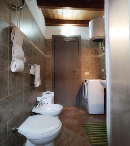 a bathroom with a toilet and a sink at Al 28ᴀ , Appartamento Teulada in Teulada