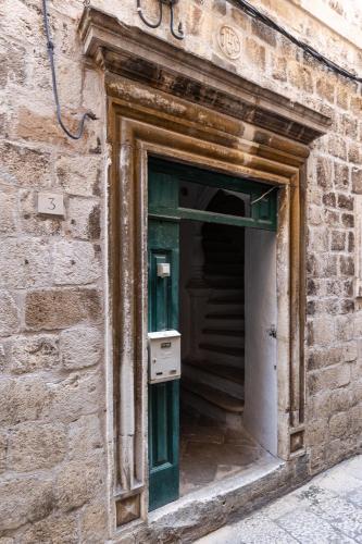 an open door of a brick building with a mailbox at Heart of Dubrovnik Old Town apartments in Dubrovnik