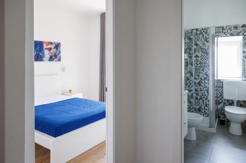 a bedroom with a bed and a bathroom at B&B In Piazza in Mafalda