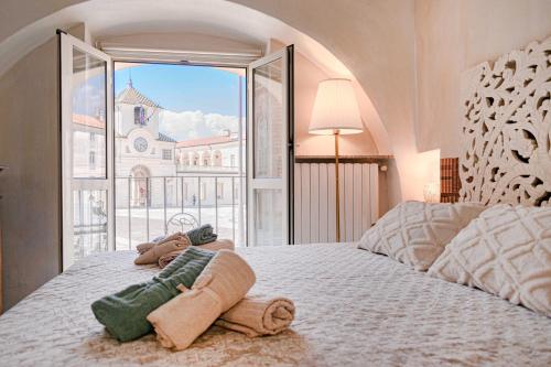 a bedroom with a bed with a large window at CASA ROYAL sulla Reggia di Venaria in Venaria Reale