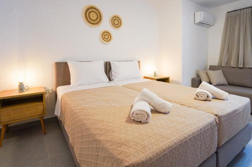 a bedroom with a bed with towels on it at Sandy feet relax suite in Kardamaina