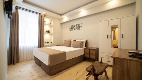 a bedroom with a large bed and a window at My Home Hotel Gulluk in Antalya