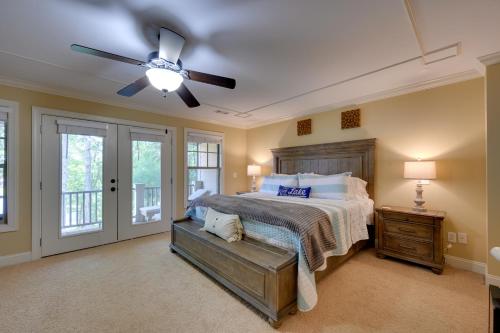 a bedroom with a bed and a ceiling fan at Lake Oconee Abode with Patio, Grill and Fire Pit Table in Eatonton 