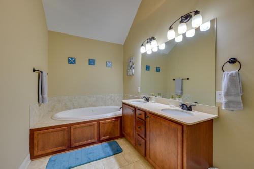 a bathroom with two sinks and a tub and a mirror at Lake Oconee Abode with Patio, Grill and Fire Pit Table in Eatonton 