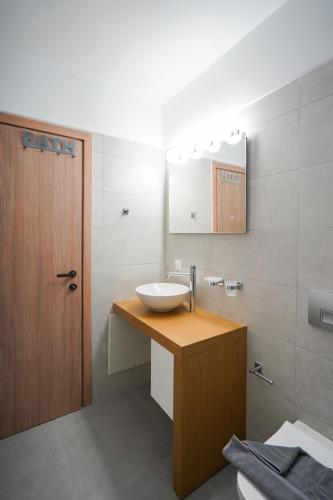 a bathroom with a sink and a mirror at Sandy feet comfort suite in Kardamaina