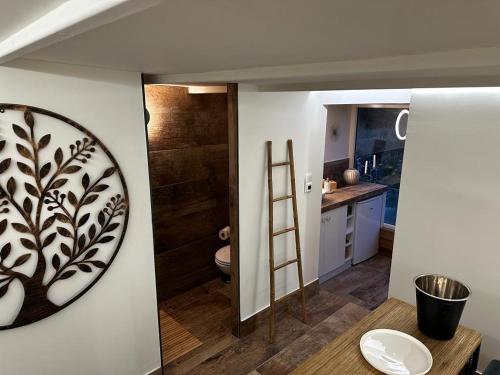 a bathroom with a sink and a toilet on a wall at Ô nature in Grez-Doiceau