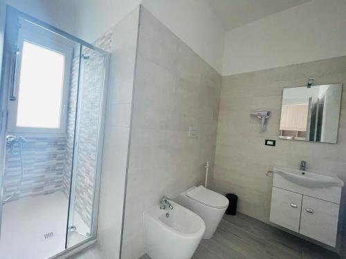 a bathroom with a shower and a toilet and a sink at Tina's House Luxury Room in Copertino