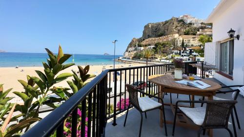 a balcony with a table and chairs and the beach at PARRALUE Beach front home in Benidorm