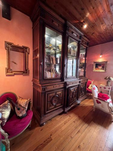 a large wooden cabinet in a room with wooden floors at Bon camino in Moissac