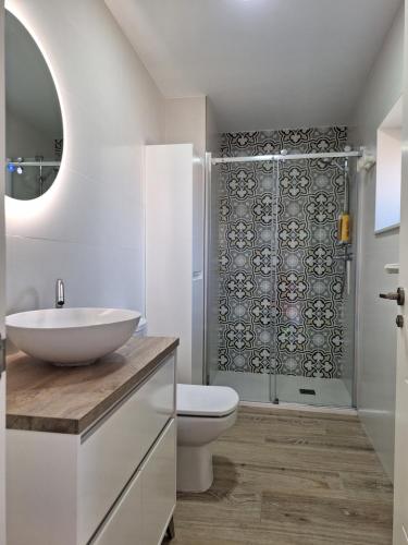 a bathroom with a sink and a toilet and a shower at A casa dos Pobres in Muxia