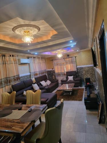 a living room with a couch and a table at S&M HOUSE in Lekki