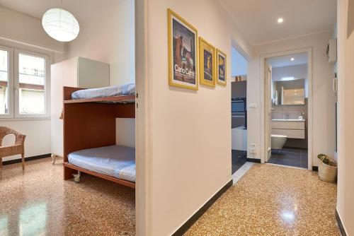 a bedroom with a bunk bed and a bathroom at sabbia bianca in Alassio