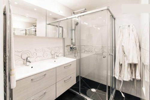 a bathroom with a shower and a sink and a glass shower stall at Croisette View Lux Flat Cannes in Cannes
