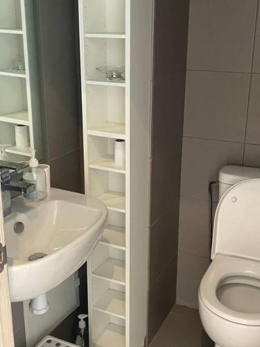 a small bathroom with a sink and a toilet at Nice appartement pool & sea view in Dar Bouazza