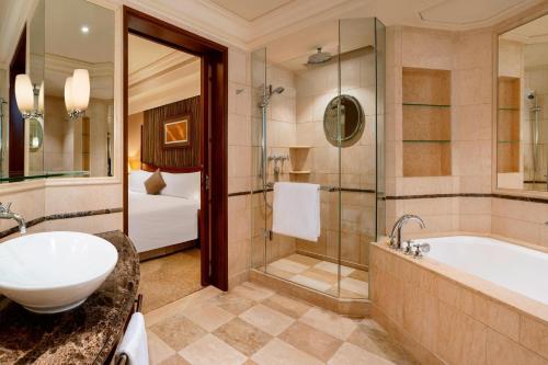 a bathroom with a tub and a shower and a sink at The Hongta Hotel, A Luxury Collection Hotel, Shanghai in Shanghai
