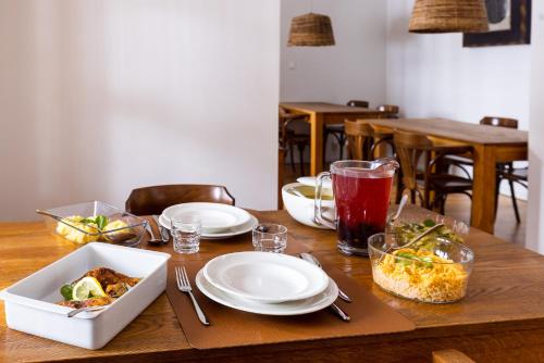 a wooden table with plates of food on it at Biały Dom W ROPKI in Ropki