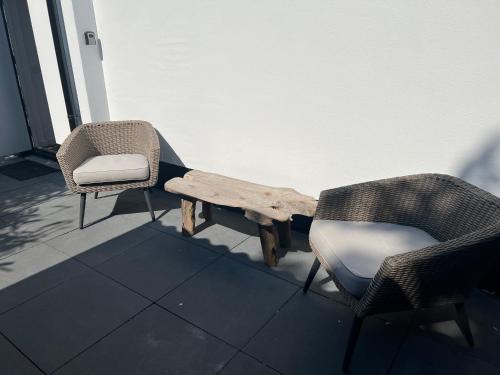 two chairs and a table and a bench on a porch at Chalet Parfait in Bergen