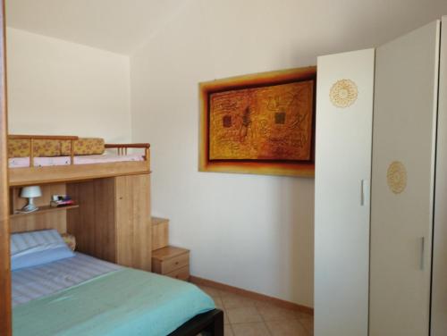 a bedroom with a bed and a bunk bed at Casa Flavia in Porto Pino