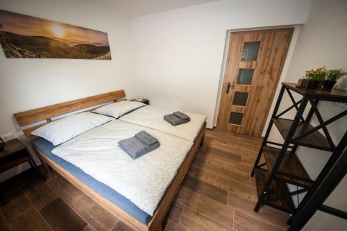 a bedroom with a bed with two pillows on it at Apartmány na Žlábku in Horní Planá