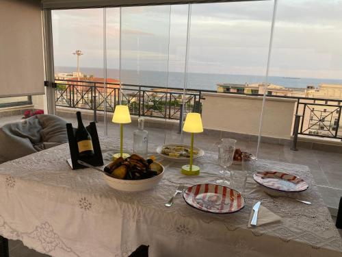 a table with a bowl of food and a view of the ocean at Samaya Sea view in Civitavecchia