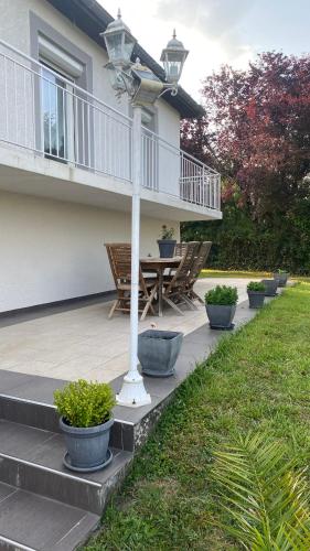 a porch with chairs and a table on a house at Maison quiétude in Chavanoz
