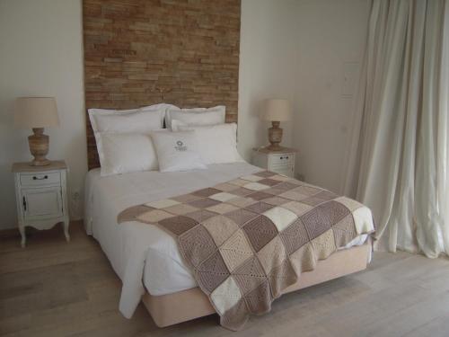 a bedroom with a large bed with two night stands at Monte do Cardal in Odeceixe