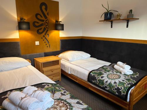 a hotel room with two beds and a rug at Domek pod Tatrami Jurgów noclegi in Jurgów