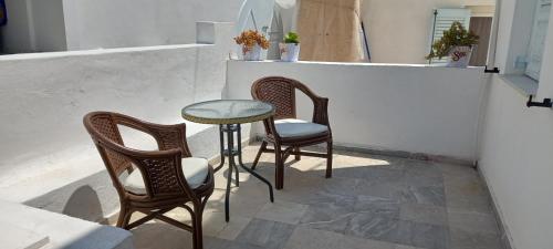 a table and two chairs and a table and a table at Dimitris Studios in Perissa