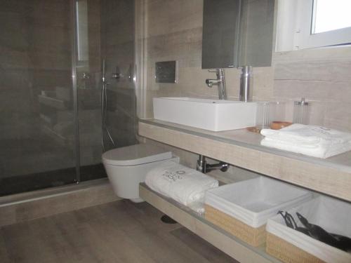 a bathroom with a toilet and a sink and a shower at Monte do Cardal in Odeceixe