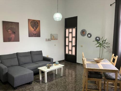 a living room with a couch and a table at Apartamento en Gran Tarajal in Gran Tarajal